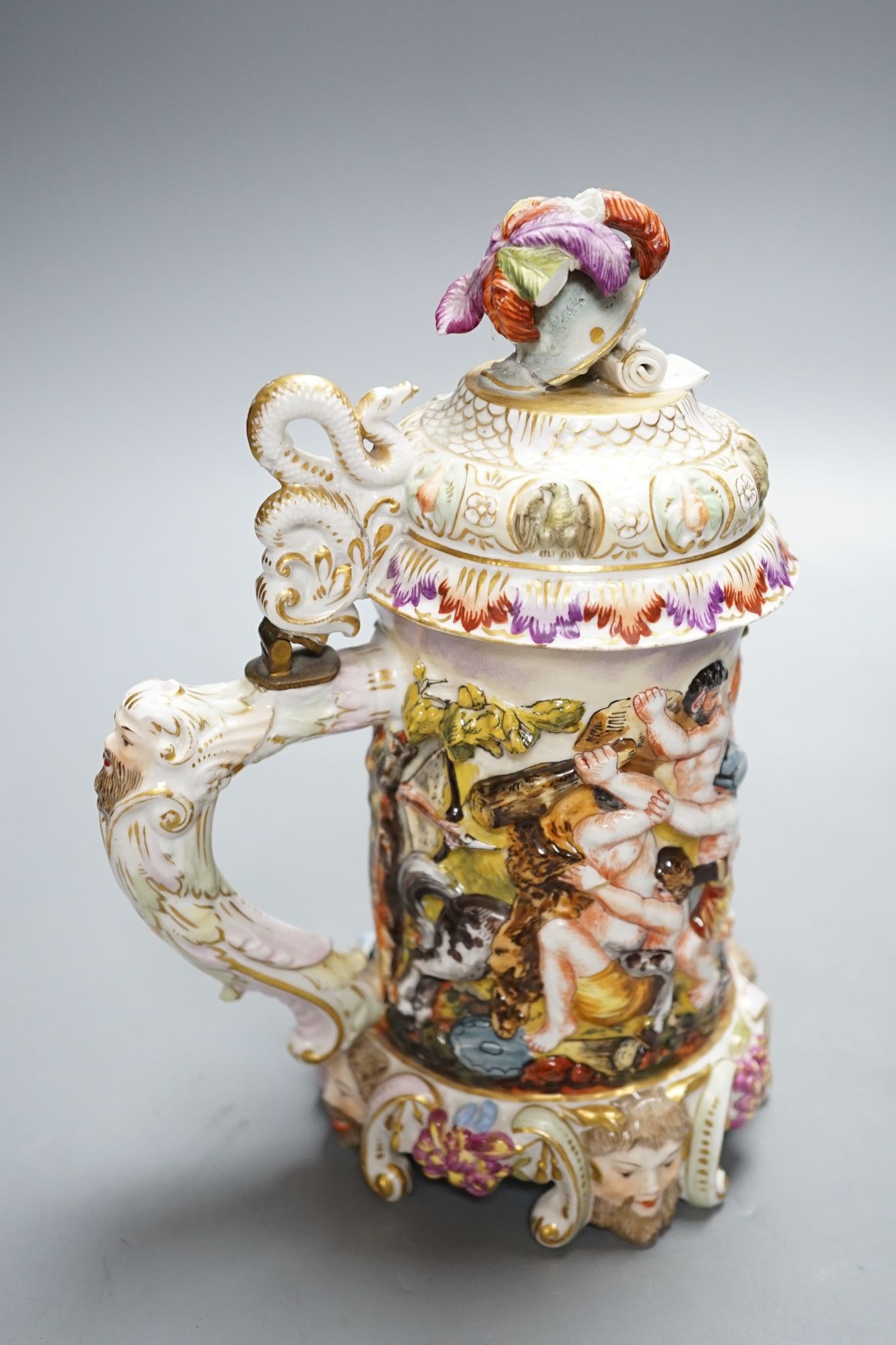 An Italian porcelain lidded tankard and matching jug, together with a cut glass lidded tankard with porcelain inset pewter lid, 22cm